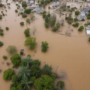 Aerial view of flooding in Texas Hill Country with visible damage and emergency responders