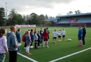 High school soccer field showcasing anti-bullying banners and students