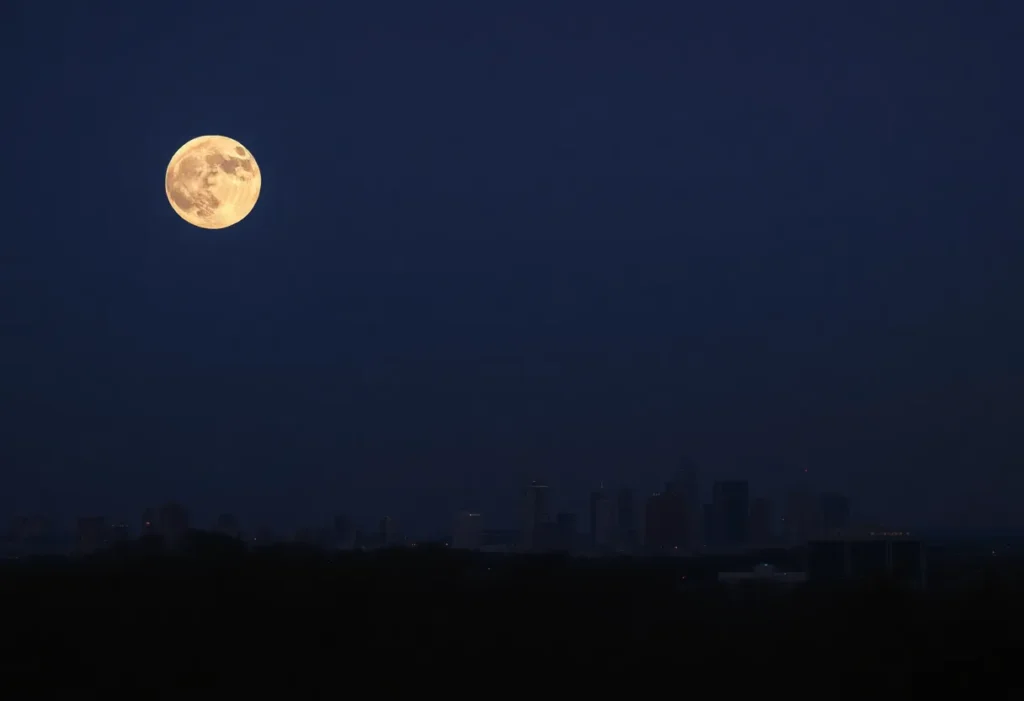 Supermoon shining brightly over the San Antonio skyline at dusk